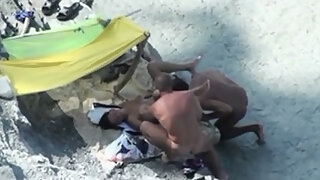 Pair lascivious on the beach caught fucking in 3some on hidden camera